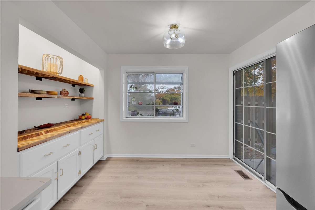 1785 Grosvenor Circle, Unit A Wheaton, IL 60189 - Photo 9 of 37 a view of a kitchen with furniture and a window
