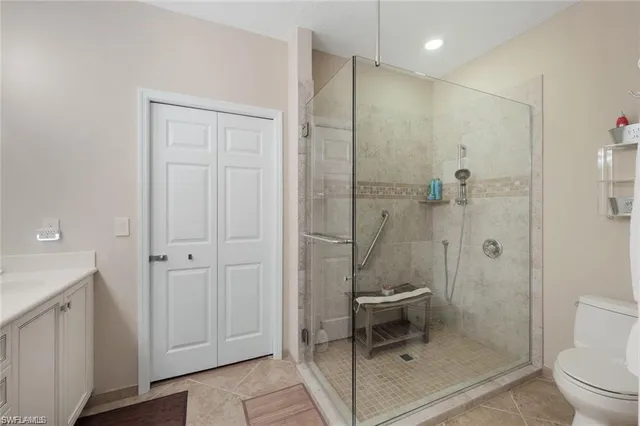 a bathroom with a shower a toilet and a sink