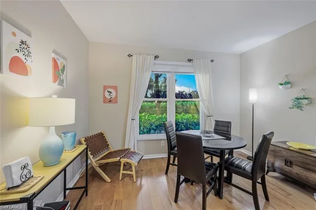 a view of a dining room with furniture and a window