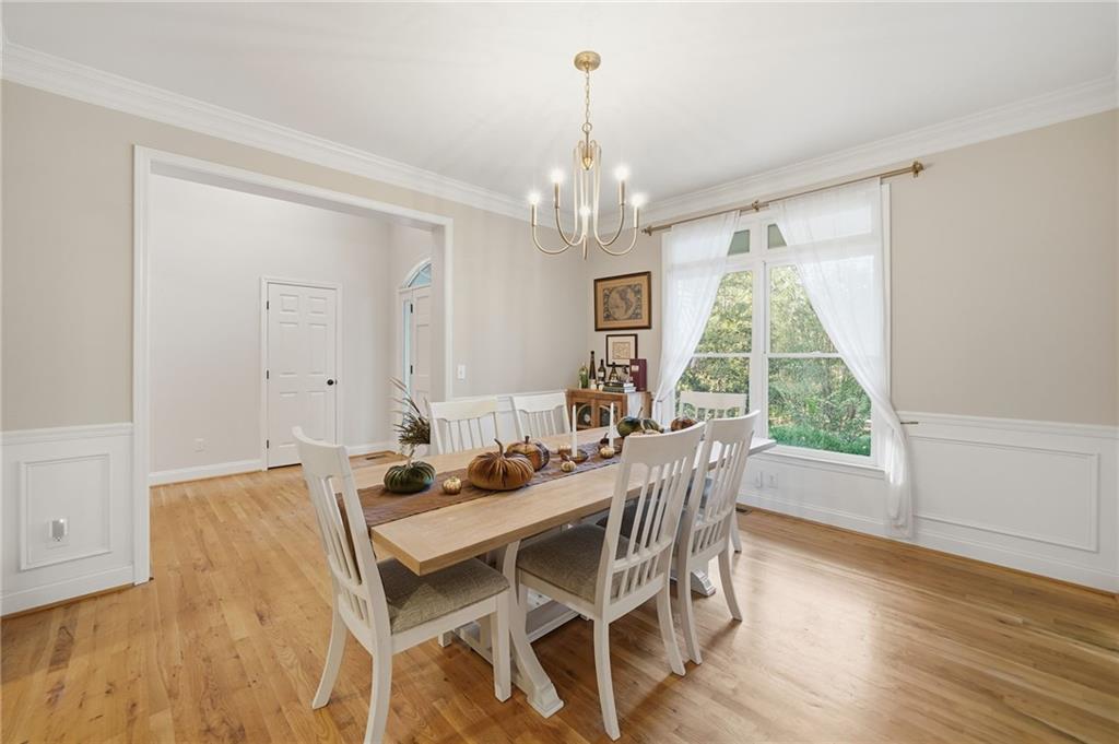 320 Allendale Drive Canton, GA 30115 - Photo 11 of 70 a dining room with furniture a chandelier and wooden floor
