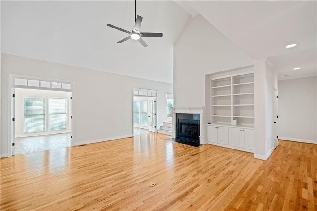 320 Allendale Drive Canton, GA 30115 - Photo 12 of 70 an empty room with wooden floor fireplace and windows