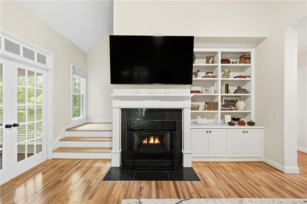 320 Allendale Drive Canton, GA 30115 - Photo 17 of 70 a living room with a fireplace and a flat screen tv