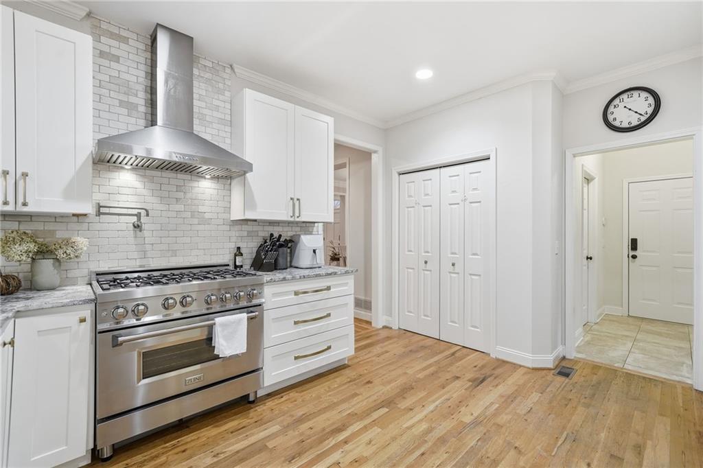 320 Allendale Drive Canton, GA 30115 - Photo 29 of 70 a kitchen with stainless steel appliances a stove and white cabinets