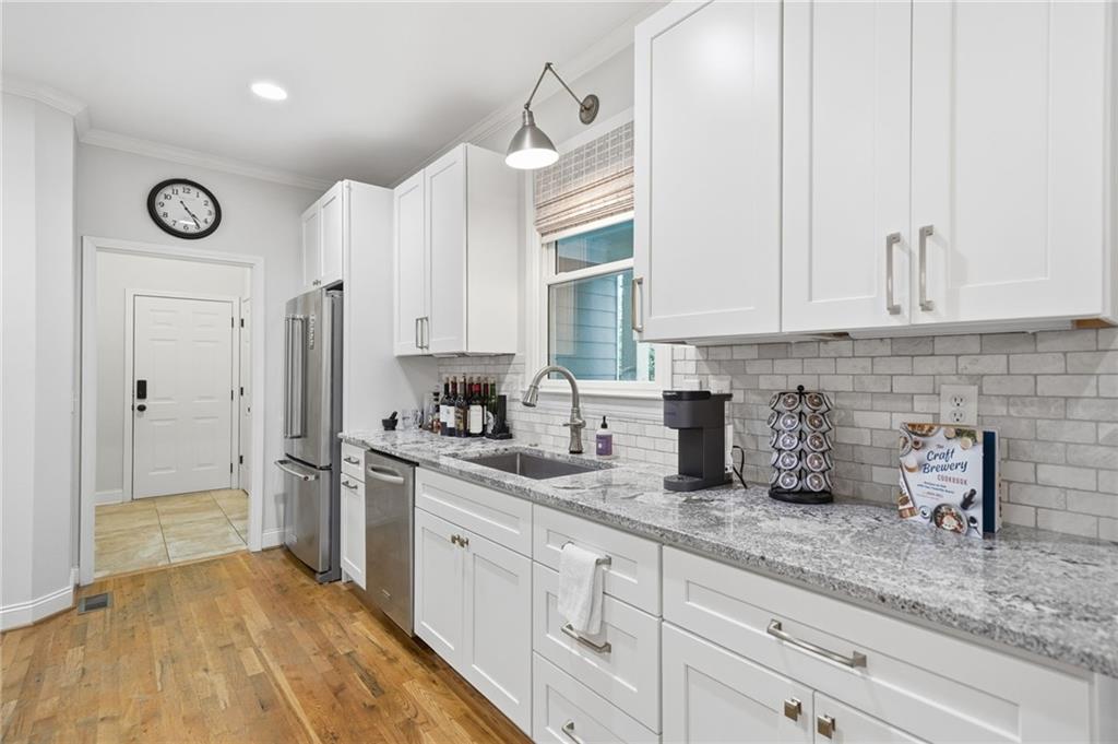 320 Allendale Drive Canton, GA 30115 - Photo 32 of 70 a kitchen with stainless steel appliances granite countertop a sink a stove and a refrigerator