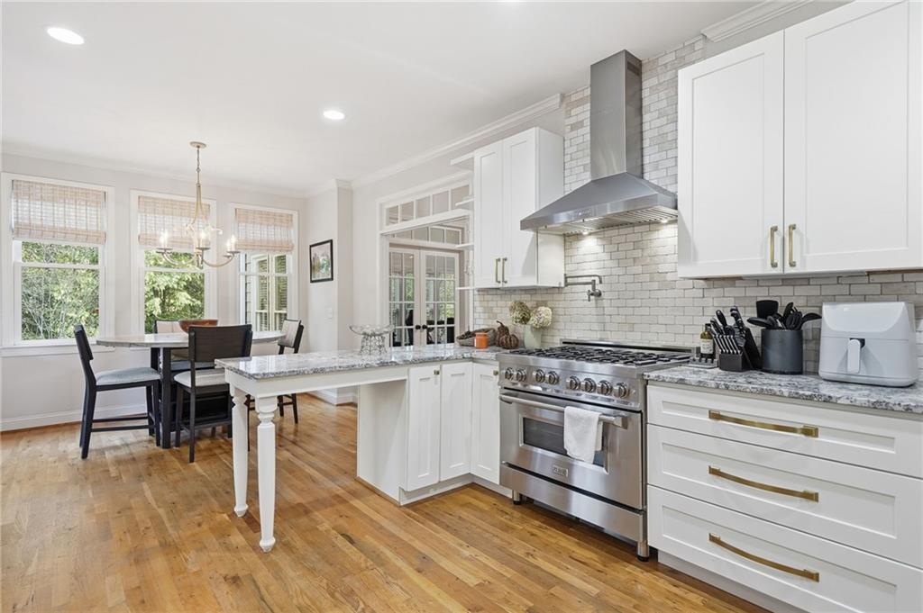320 Allendale Drive Canton, GA 30115 - Photo 34 of 70 a kitchen with stainless steel appliances a white stove top oven cabinets and a wooden floor