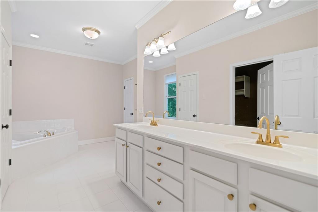 320 Allendale Drive Canton, GA 30115 - Photo 43 of 70 a bathroom with a sink double vanity granite tub and a mirror