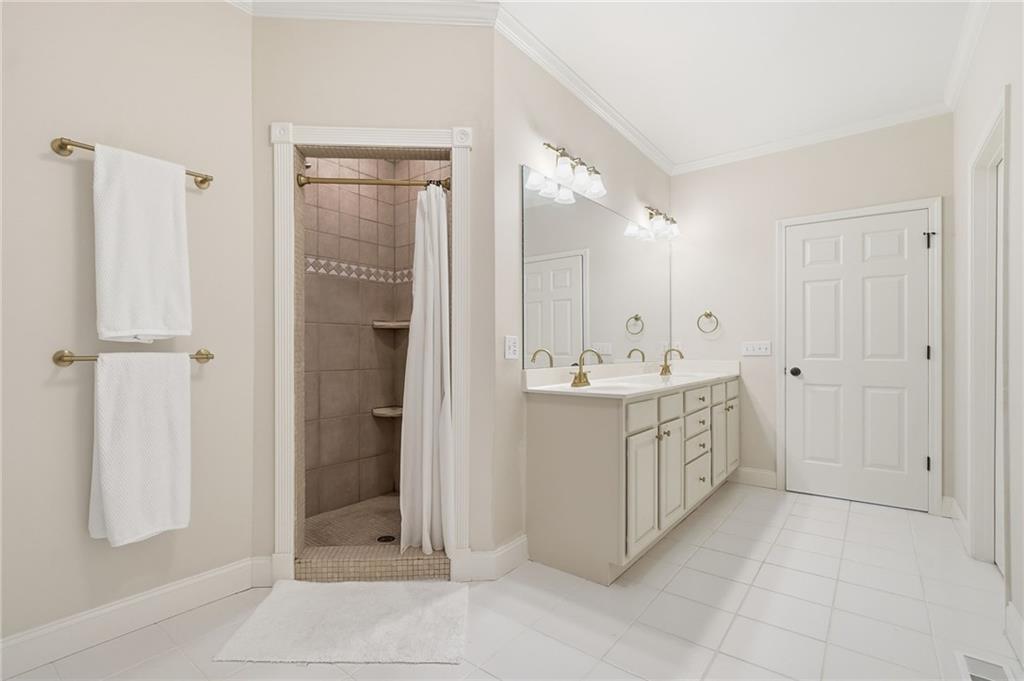 320 Allendale Drive Canton, GA 30115 - Photo 48 of 70 a bathroom with a double vanity sink a mirror and a shower