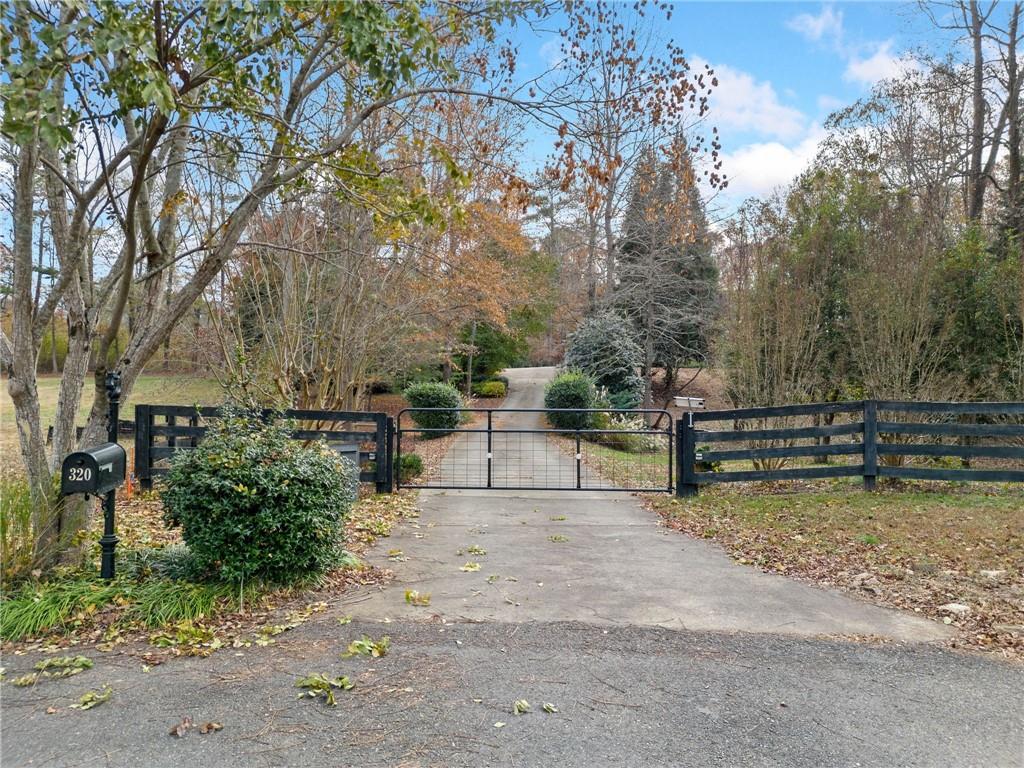 320 Allendale Drive Canton, GA 30115 - Photo 5 of 70 a view of backyard with wooden fence and trees