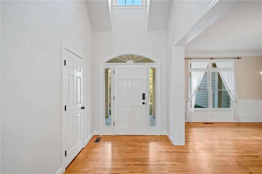320 Allendale Drive Canton, GA 30115 - Photo 6 of 70 a view of an empty room with wooden floor and a window