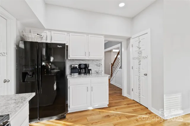 a kitchen with a refrigerator and cabinets