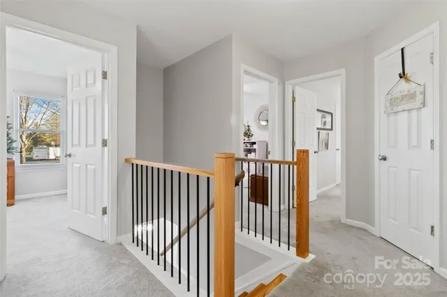 a view of a hallway with wooden floor and door