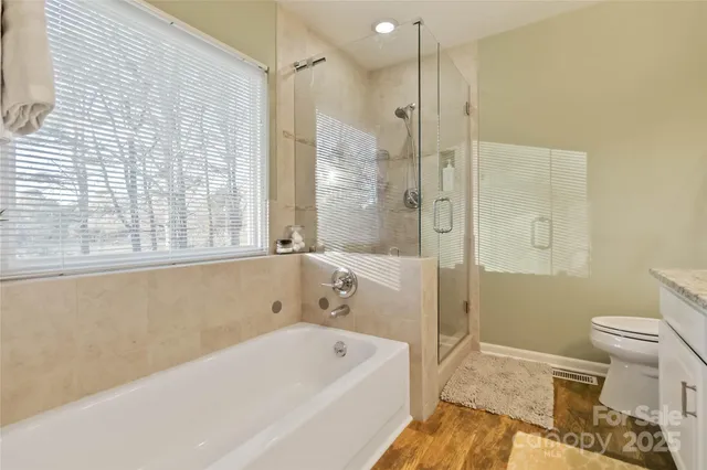 a bathroom with a bathtub a toilet and a shower