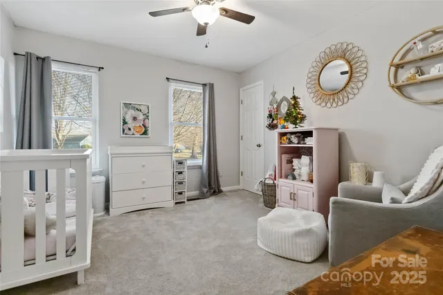 a living room with furniture a chandelier and a window
