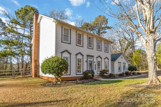 a front view of houses with yard