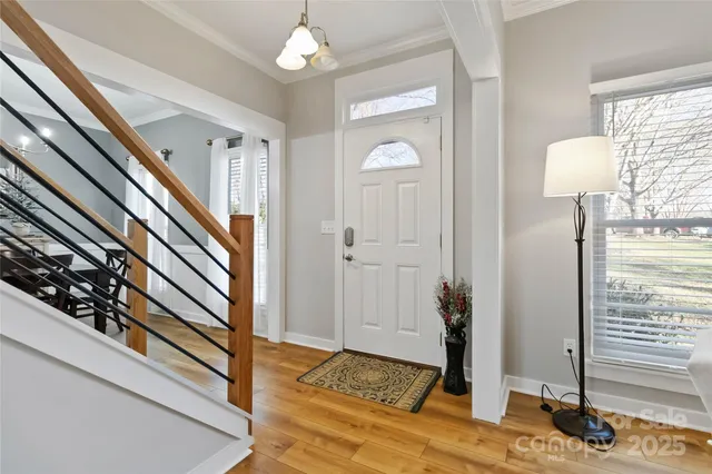 a view of a livingroom with wooden floor and a chandelier