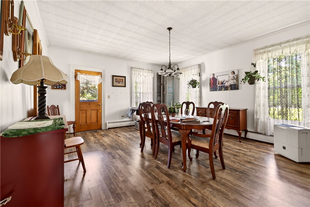 7780 Cold Springs Road Bath, NY 14810 - Photo 10 of 50 Gleaming wood-look floors and character-filled ceilings define this inviting dining room space.