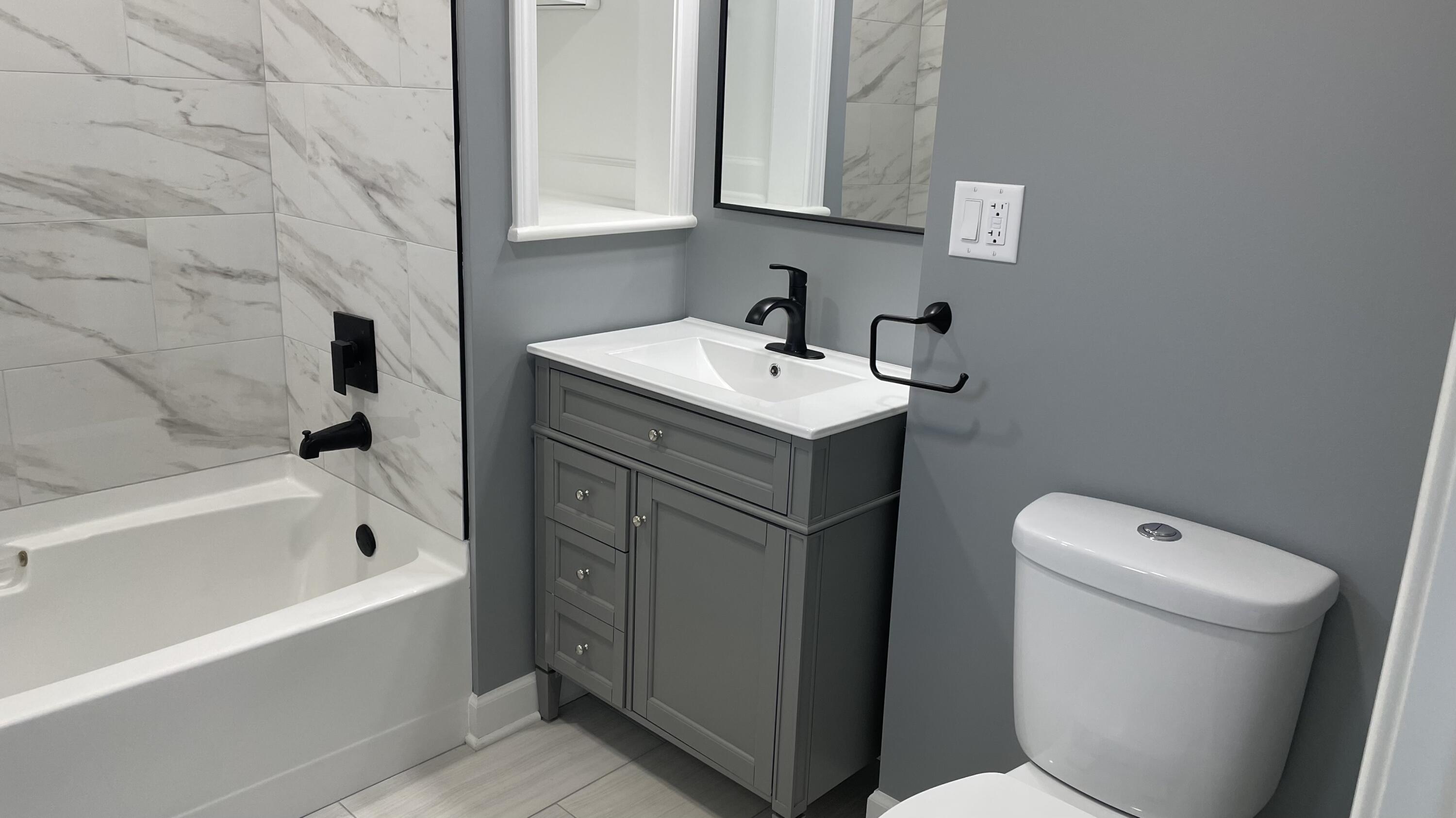 3362 Virginia Street Gary, IN 46409 - Photo 12 of 29 a bathroom with a sink a toilet and bathtub