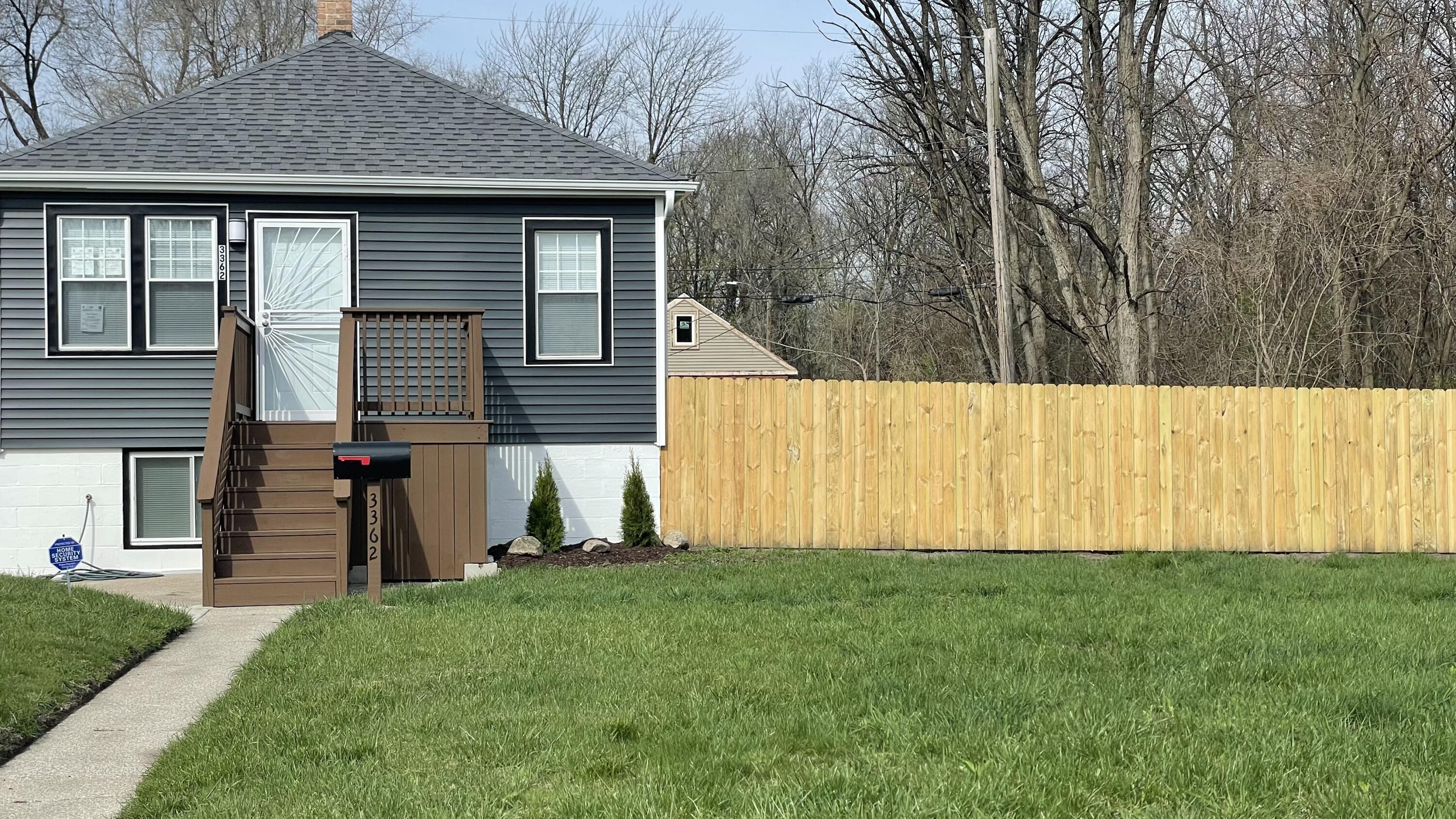 3362 Virginia Street Gary, IN 46409 - Photo 2 of 29 a view of a backyard with potted plants and large tree