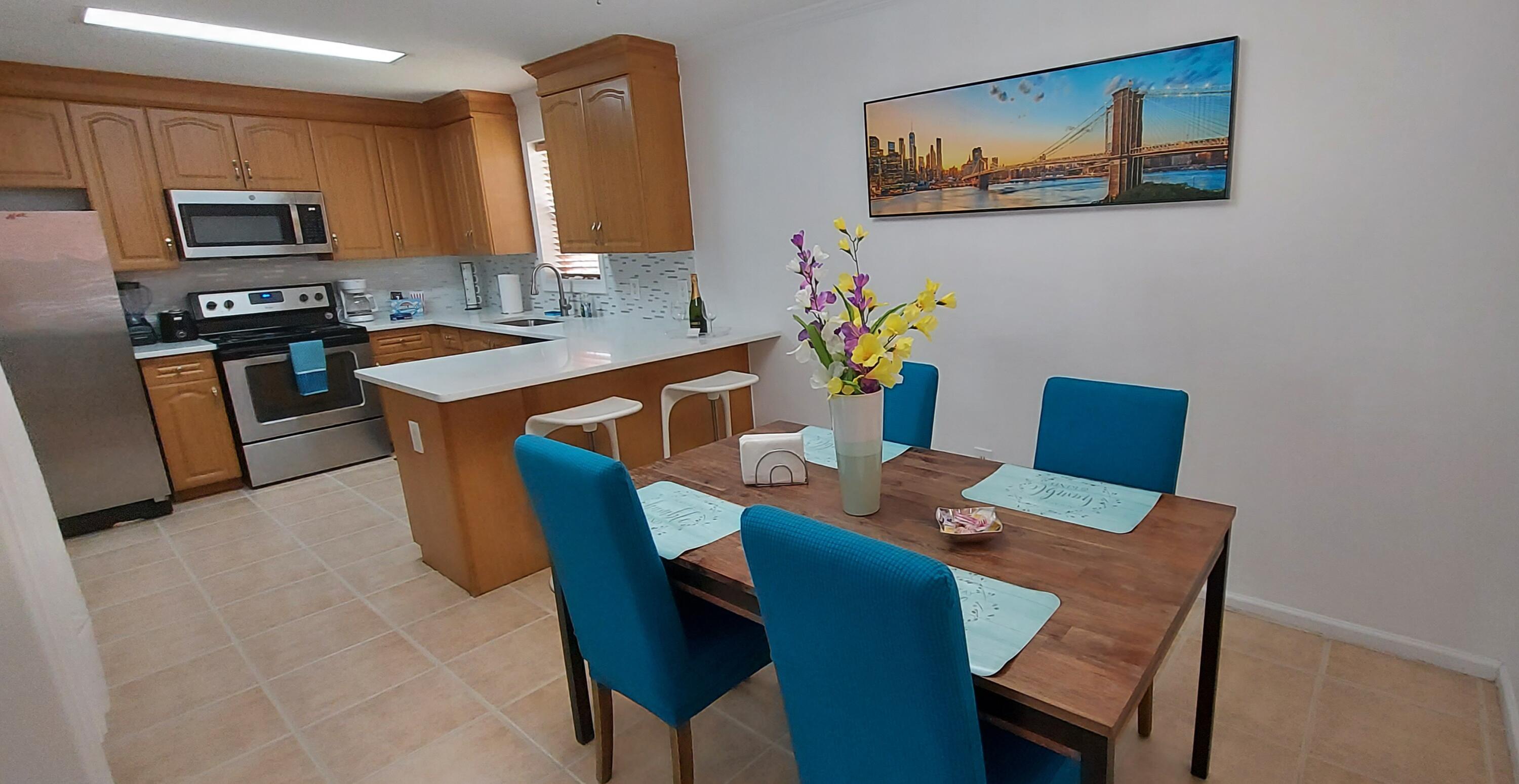 a dining room with furniture a kitchen island a stove a kitchen island a dining table and chairs