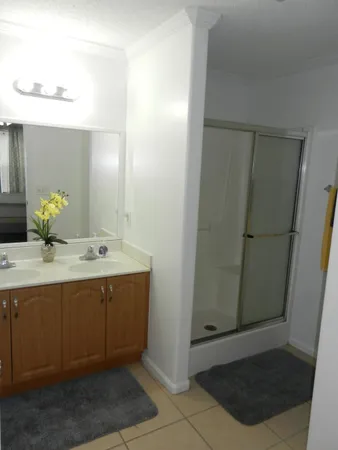 a bathroom with a double vanity sink and a mirror