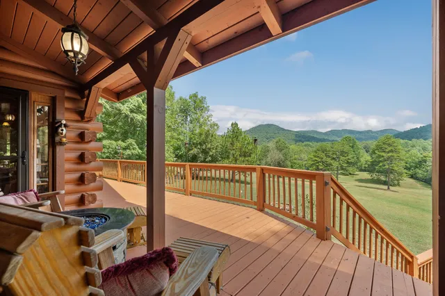 a room with stainless steel appliances kitchen island granite countertop a table chairs in it and a window