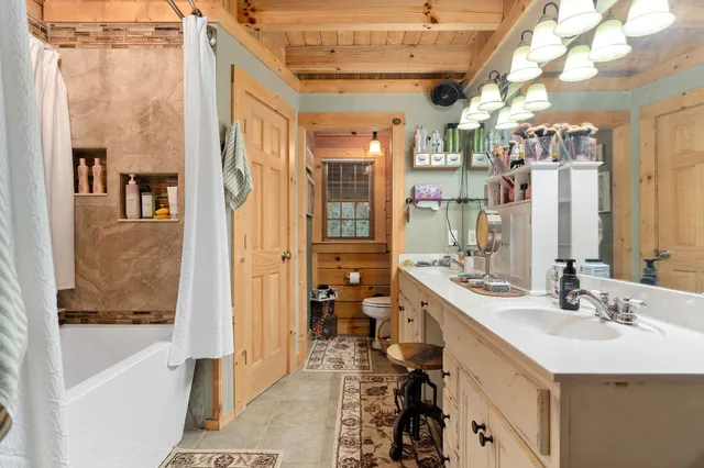 a kitchen with stainless steel appliances granite countertop a stove a sink dishwasher and cabinets with wooden floor