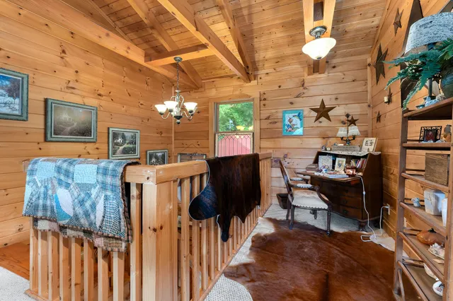 a living room with furniture a rug and a chandelier