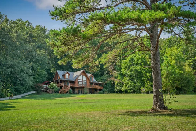 a view of a house with a yard and a large pool