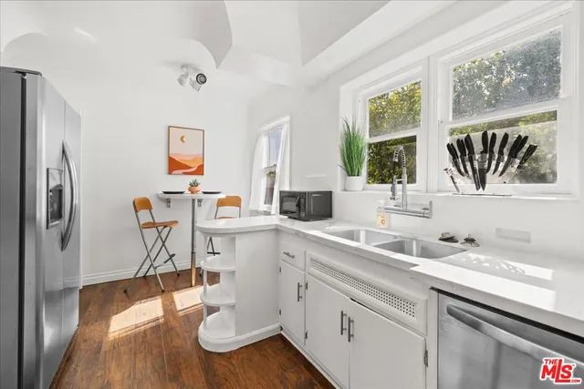 a kitchen with a sink cabinets and window