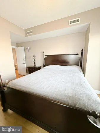 a large bed sitting in a bedroom next to a lamp