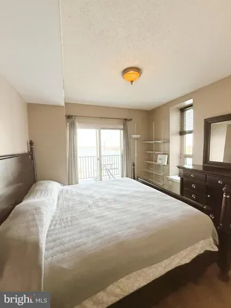 a bedroom with a bed and a large window