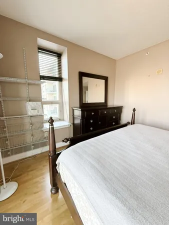 a bedroom with a bed and a window