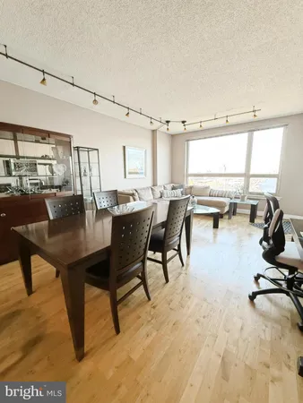 a dining room with furniture and a window