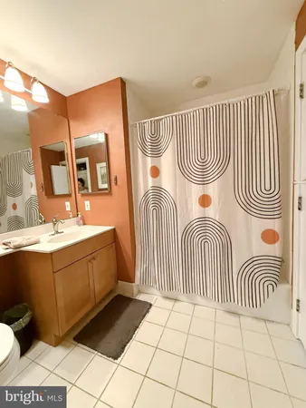 a bedroom with a sink and a mirror
