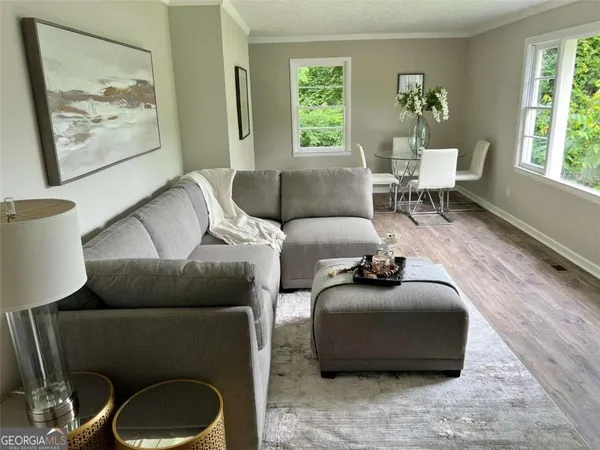 a living room with furniture and a large window