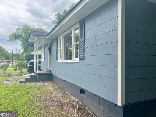 a view of house with backyard
