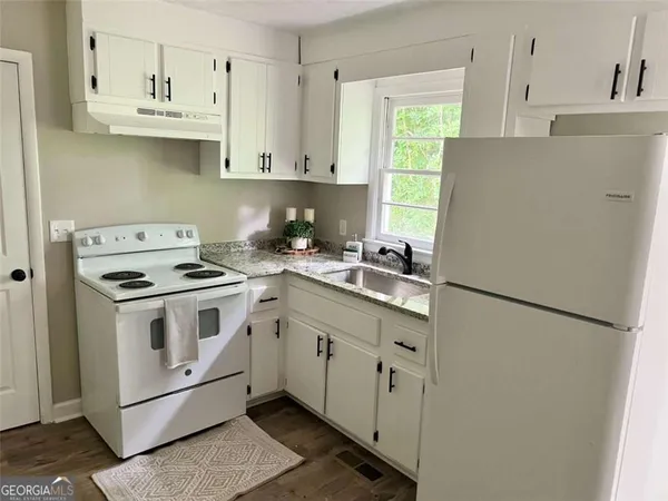 a white refrigerator freezer sitting inside of a kitchen