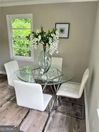 a view of a dining room with furniture window and wooden floor