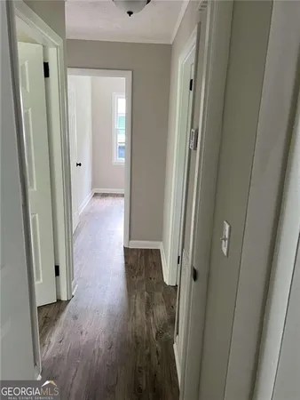 a view of a hallway with wooden floor