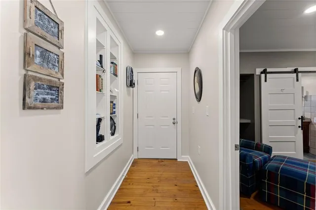 a living room with furniture and a dining table with wooden floor