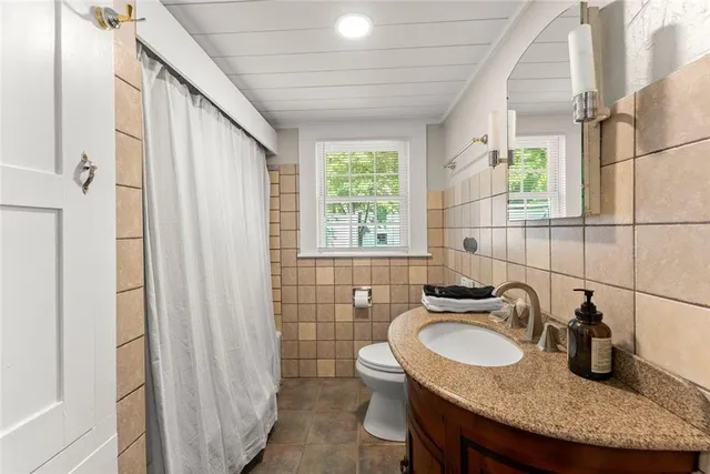 a kitchen with a sink a stove and cabinets