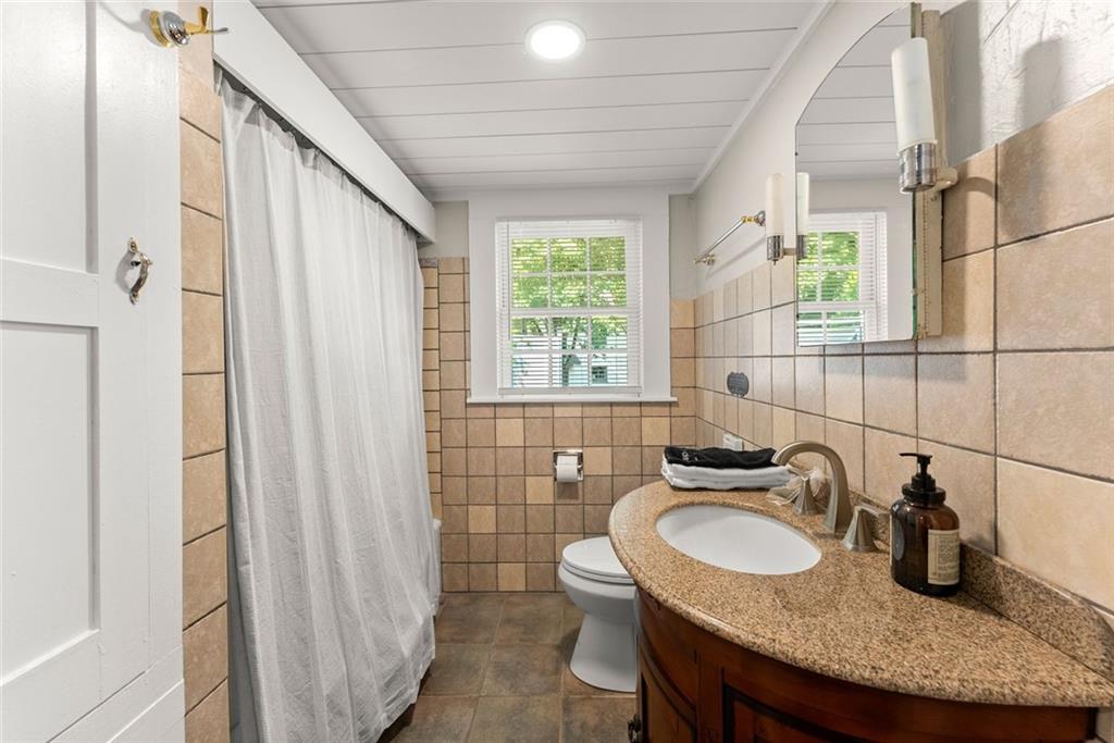 168 West Main Street Dahlonega, GA 30533 - Photo 34 of 118 a bathroom with a granite countertop sink and a mirror