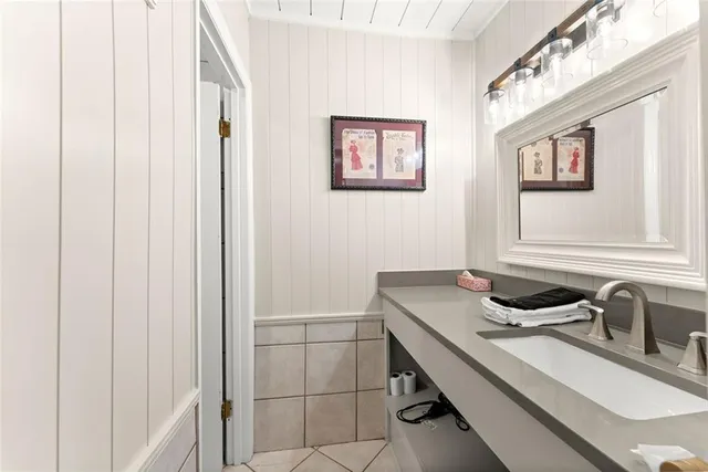 a kitchen with stainless steel appliances granite countertop a refrigerator a stove and a sink with wooden floor