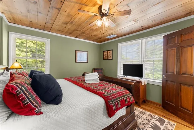 an aerial view of residential house with outdoor space and trees all around