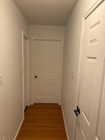 a view of a room with wooden floor