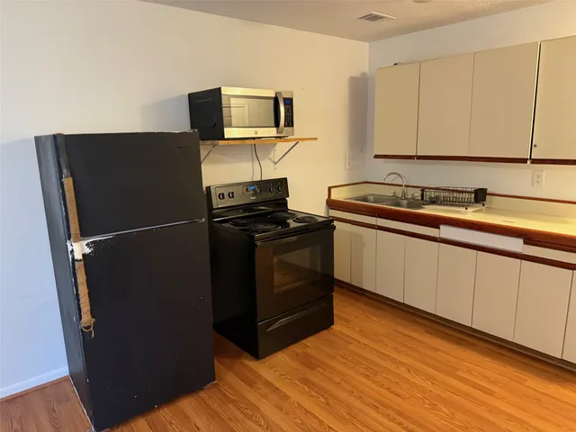 a kitchen with a sink and a stove top oven