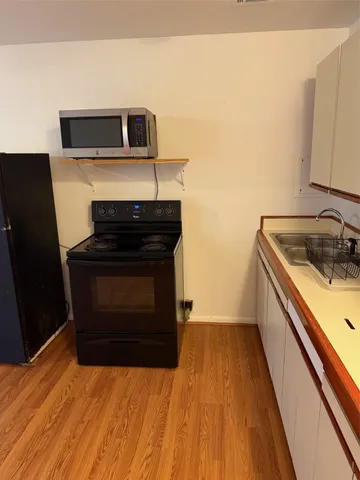 a kitchen with a stove and a microwave