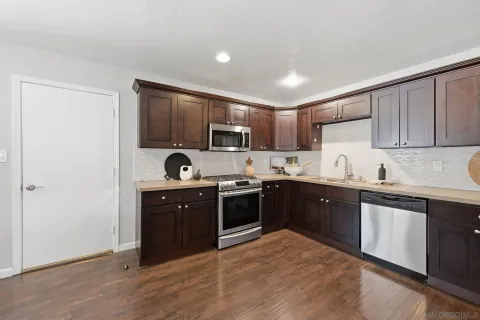 a kitchen with a sink cabinets and stainless steel appliances