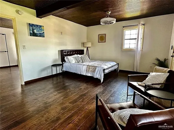 a bed room with furniture and wooden floor