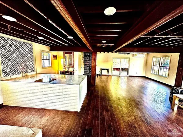 a view of a room with wooden floor